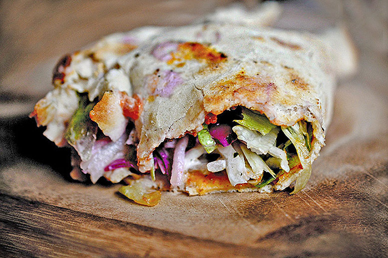 Lahmacun rolled up with fresh salad