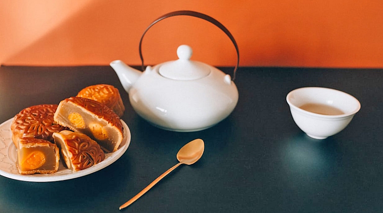 mooncakes on a saucer and a cup of tea